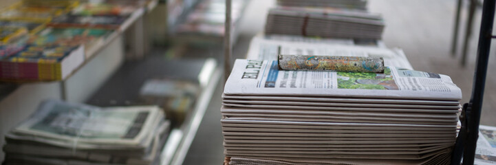 Newspapers are sold on the street. Information, news on paper.