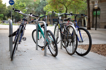 Bicycles parked on a city street. Healthy lifestyle. Caring for the environment.