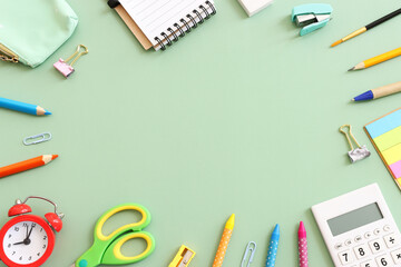 Back to school concept on pastel green background. Top view