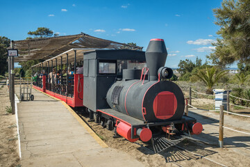 Retro train at Barril beach near Tavira, Portugal.