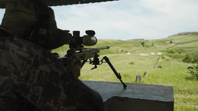 The shooter takes aim and shoots the rifle at the targets. Shooting practice