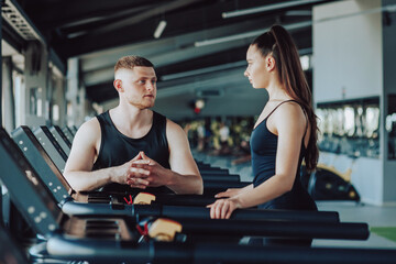 the valuable dialogue between a knowledgeable personal trainer and a female client, as they discuss exercise routines, fitness progress, and the path to a healthier lifestyle.