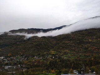 Clouds on mountains green valley white sky foggy