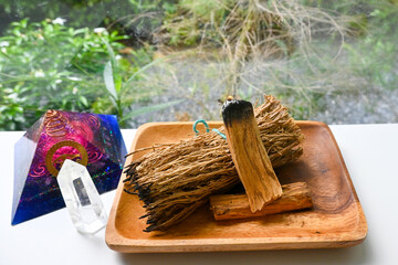 Smudge kit for spiritual practices with natural elements: Palo Santo sticks, dried white sage, Orgonite pyramid and clear quartz sphere. Ritual spirituality, self care mind and soul practicing.
