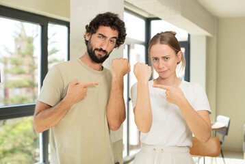 Obraz premium young adult couple looking impatient and angry, pointing at watch, asking for punctuality, wants to be on time