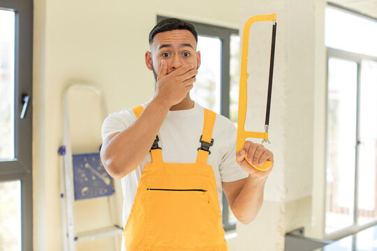 arab handsome man arab man covering mouth with a hand and shocked or surprised expression. handyman concept