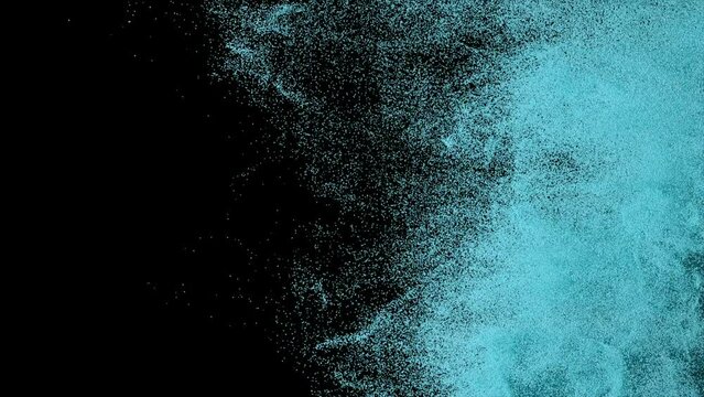 Colored powder scatters on a black isolated background. Sand. Spray. Blue color. Slow motion. 3d animation.