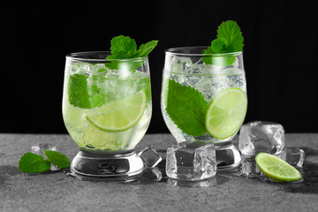 Close-up of two glasses of mojito cocktail on a dark background. Low angle view. Studio shot.