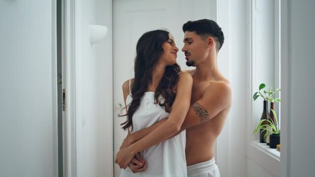 Affectionate people embracing at light flat close up. Couple touching noses