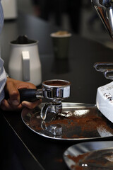 professional barista preparing ground coffee