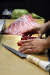chef cutting tuna for sushi