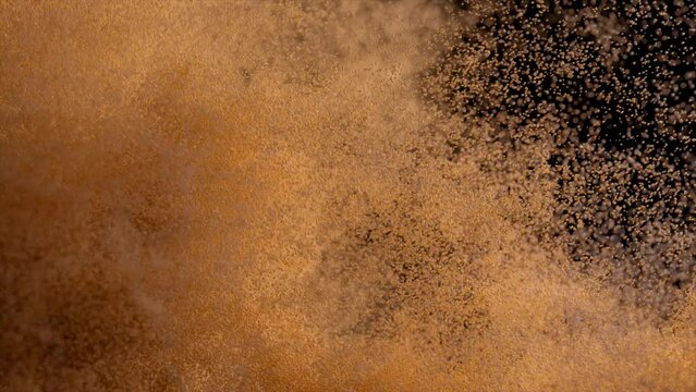 Bronze sand cover blown off on a black isolated background. Airflow. Grains of sand. Slow motion. 3d animation
