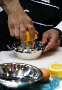 bartender squeezing juice in a juicer