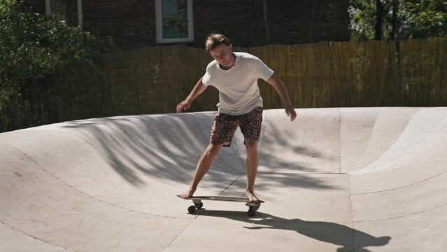 A young and agile skater rides on the ramp for his pleasure. Surfskate is an interesting board for skating.