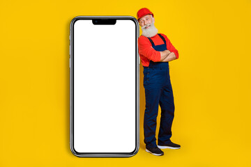 Photo of artisan architect workman advertise reconstruction service smart phone poster isolated on shine color background