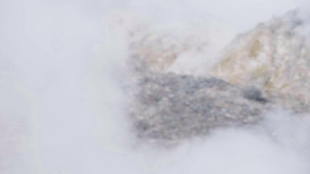 4K video of the crater, thick smoke blankets the area