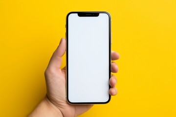 Mockup image of a person holding mobile phone with blank desktop screen isolated on yellow background