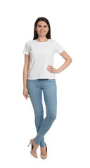 Fototapeta premium Happy woman wearing stylish light blue jeans and high heels shoes on white background