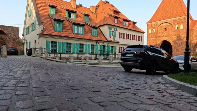 Old street. Stroll through the historic streets of the old town. Facades of historic buildings. Torun, Poland.