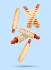 Yummy French hot dogs with grilled buns falling on light blue background