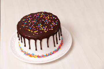 children's birthday cake, with chocolate and colorful candies on top. Cake concept. Confectionery concept.