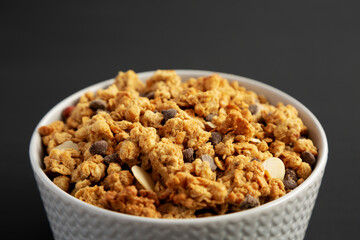 Protein Granola with hazelnut, almond, and chocolate in a Bowl, side view.