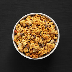 Protein Granola with hazelnut, almond, and chocolate in a Bowl, top view.