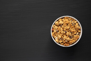 Protein Granola with hazelnut, almond, and chocolate in a Bowl, top view. Copy space.