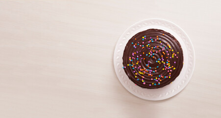 children's birthday cake, with chocolate and colorful candies on top. Cake concept. Confectionery concept.