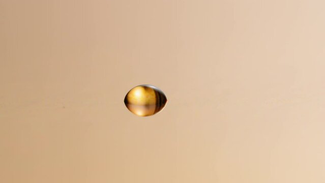 Golden drop of water on the surface - reflection, abstract, background, overlay, concept