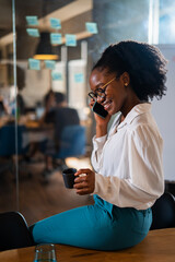 Happy businesswoman in office. Portrait of beautiful businesswoman using the phone.