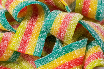 Rainbow sour jelly candies strips in sugar sprinkle