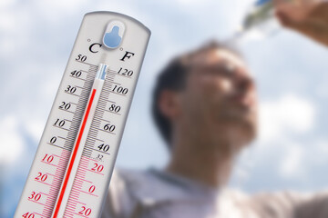 Man pouring water on his head in extreme heat, Thermometer in summer day shows or indicate high temperature