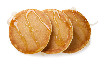 Pancakes poured with syrup on a white. Top view