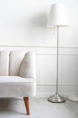 Cozy home interior Light vintage sofa and floor lamp in a light interior. Minimalist home design....
