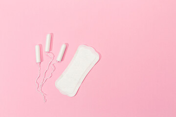 women's tampon and women's pad on pink background