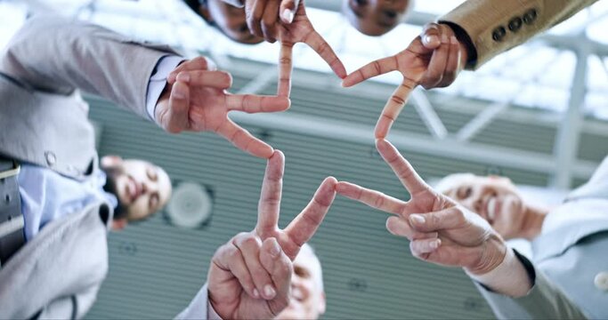 Star, teamwork or hands of business people in huddle for motivation, group mission or collaboration. Team building, low angle or colleagues in meeting with peace sign, vision or solidarity in office