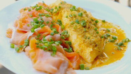 Scrambled Eggs with Salmon. A balanced breakfast option, featuring scrambled eggs mixed with salmon and vegetables. Tasty and nutritious, perfect for starting your morning right.