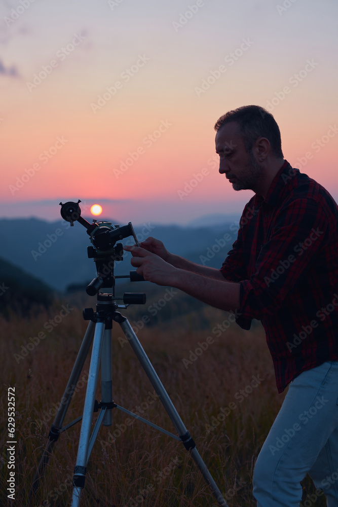 Canvas Prints astronomer looking at the sun with a telescope and using a cellphone.