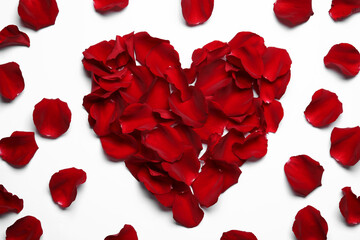 Beautiful heart of red rose petals on white background, top view