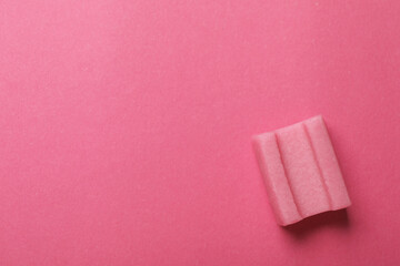 Tasty chewing gum on pink background, top view. Space for text