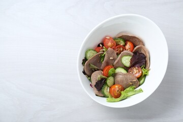 Delicious salad with beef tongue and vegetables on white wooden table, top view. Space for text