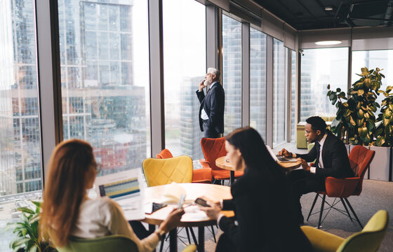Group of diverse businesspeople working in office cafeteria - Powered by Adobe