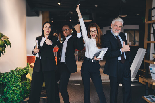 Diverse colleagues celebrating success in office