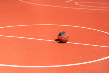 Close-up of a basketball that lies on the floor of a basketball court in a park the concept of love for basketball 