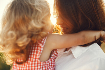 Mother with daughter playing in a summer field