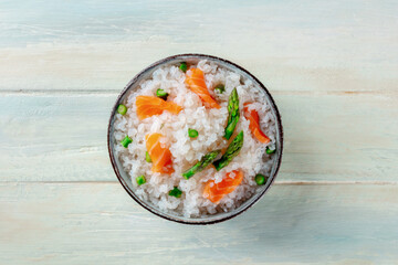 Konjac rice. Shirataki with salmon and asparagus, a healthy diet dish, top flat lay shot on a wooden background