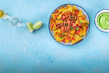 Nachos, Mexican food, tortilla chips with beef and fresh vegetables, overhead shot with a place for text