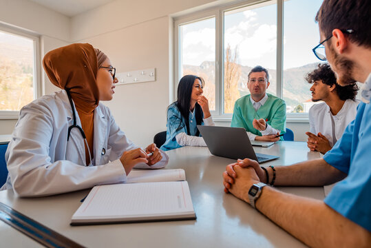 A medical team of doctors discussing at a meeting in the conference room.
