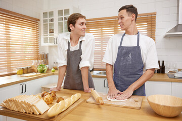 LGBT gay couple making a bread together in the kitchen
